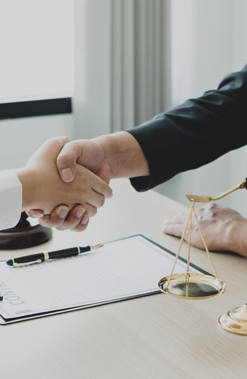 shake hand Professional man lawyers work at a law office There are scales, Scales of justice, judges gavel, and litigation documents. Concepts of law and justice.